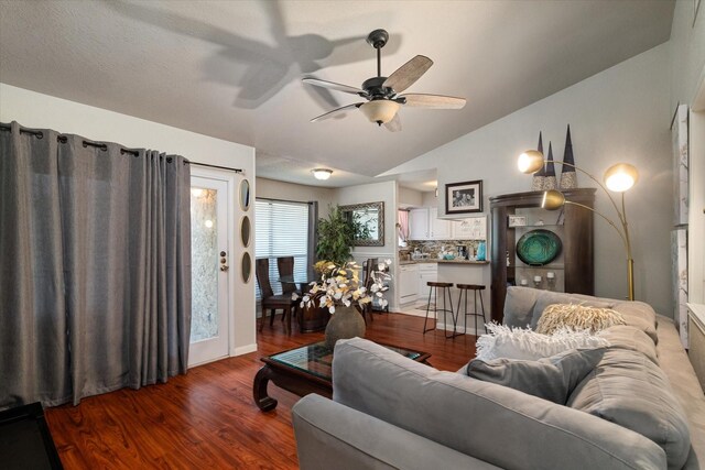 living room featuring hardwood / wood-style flooring, ceiling fan, and lofted ceiling