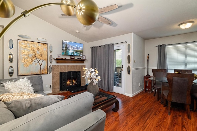 living room with dark hardwood / wood-style flooring, a fireplace, lofted ceiling, and ceiling fan