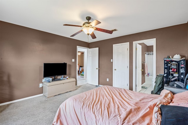 carpeted bedroom with connected bathroom and ceiling fan