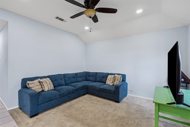 living room with ceiling fan, vaulted ceiling, and light carpet