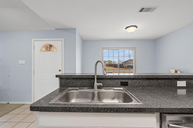 kitchen with dishwasher, light tile patterned flooring, and sink