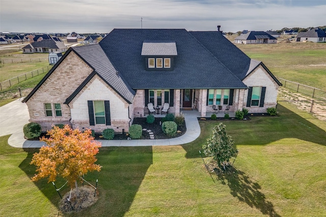 view of front of house with a patio and a front lawn