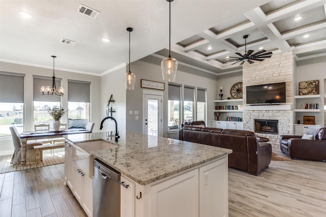 kitchen featuring white cabinets, dishwasher, and a healthy amount of sunlight