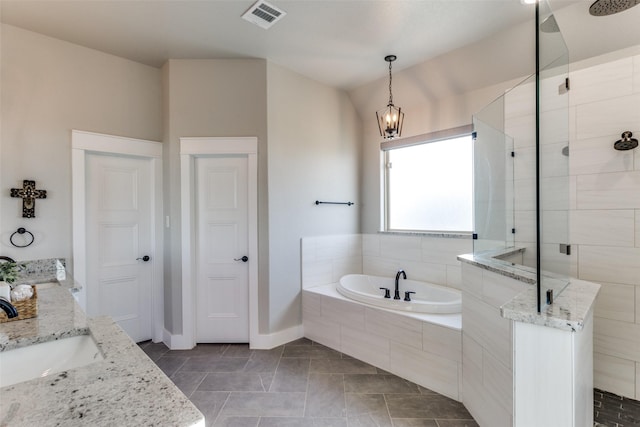 bathroom with tile patterned flooring, vanity, independent shower and bath, and a notable chandelier