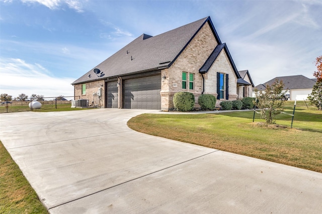 view of property exterior featuring a lawn, central AC, and a garage