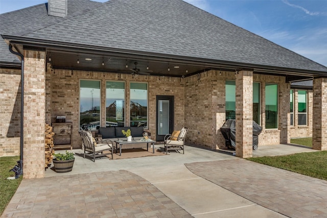 rear view of house with an outdoor living space, ceiling fan, and a patio area