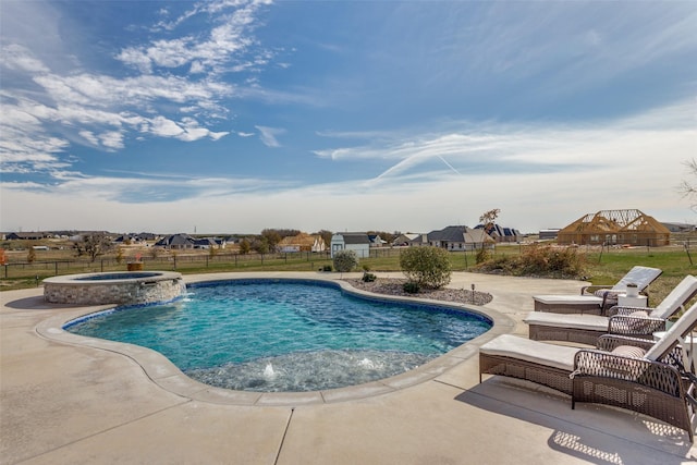 view of swimming pool featuring pool water feature, an in ground hot tub, and a patio