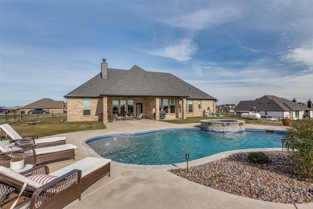 view of swimming pool with a patio area, pool water feature, and an in ground hot tub