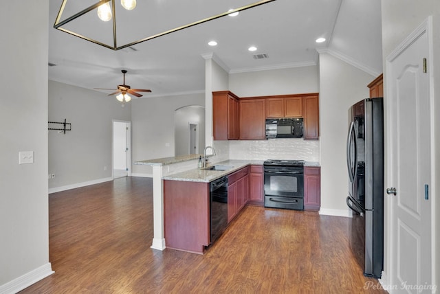 kitchen with sink, ornamental molding, black appliances, light stone countertops, and kitchen peninsula