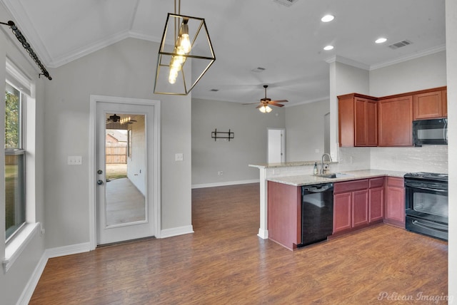 kitchen with sink, light stone counters, black appliances, light hardwood / wood-style floors, and kitchen peninsula