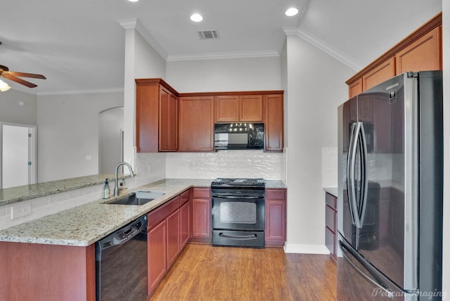 carpeted empty room featuring ornamental molding, ceiling fan, and a tray ceiling