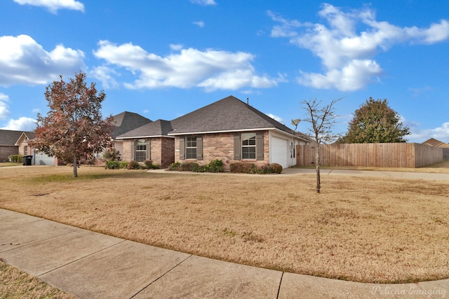 ranch-style home featuring a garage and a front yard