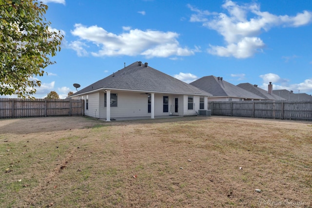 back of property featuring a yard and cooling unit