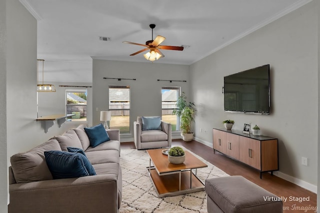 living room with crown molding, ceiling fan, and light wood-type flooring