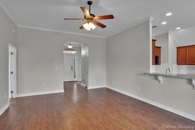 unfurnished room with ornamental molding, dark hardwood / wood-style floors, and ceiling fan