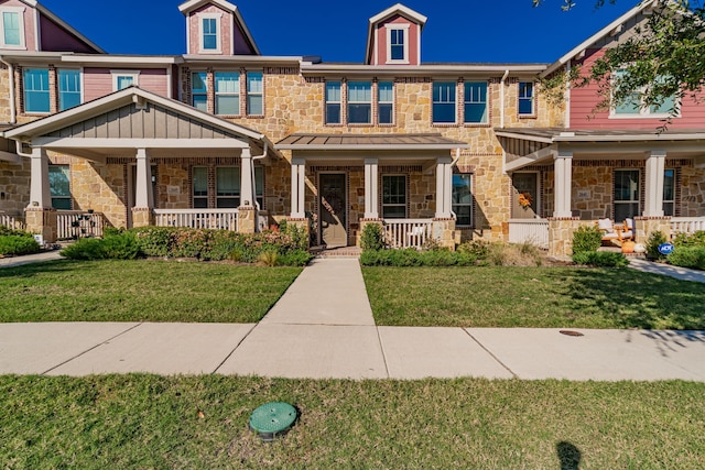 view of front facade with covered porch and a front yard