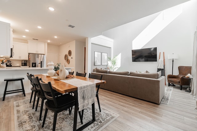 dining space with light wood-type flooring