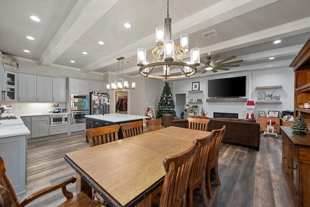 dining room featuring beamed ceiling, ornamental molding, ceiling fan with notable chandelier, and dark hardwood / wood-style flooring