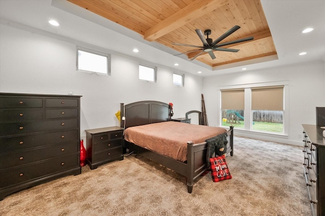 bedroom featuring multiple windows, light carpet, wood ceiling, and a tray ceiling