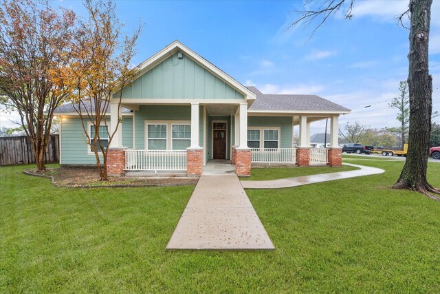 craftsman house with covered porch and a front yard