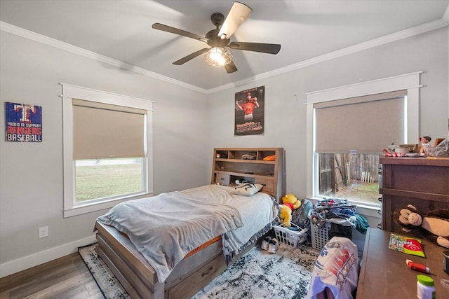 bedroom featuring hardwood / wood-style flooring, ornamental molding, and ceiling fan