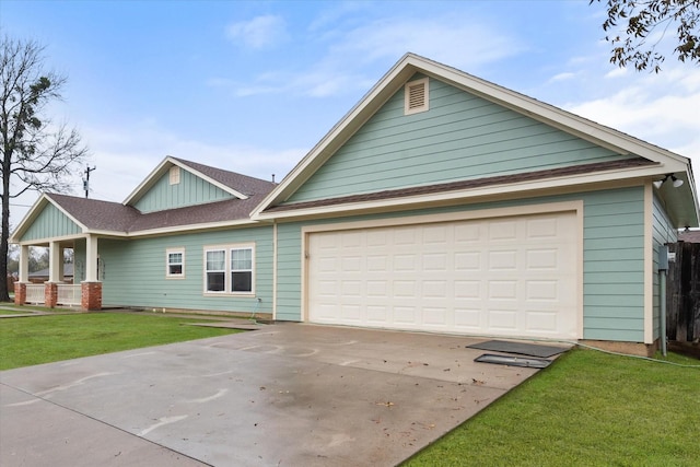 view of front facade with a garage, a front yard, and covered porch