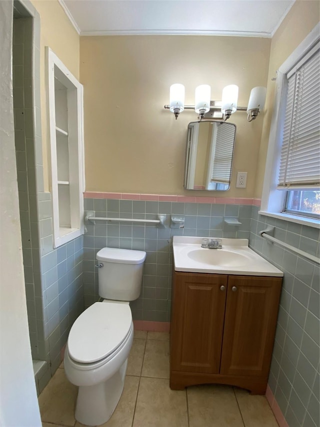 bathroom with ornamental molding, vanity, tile walls, tile patterned flooring, and toilet