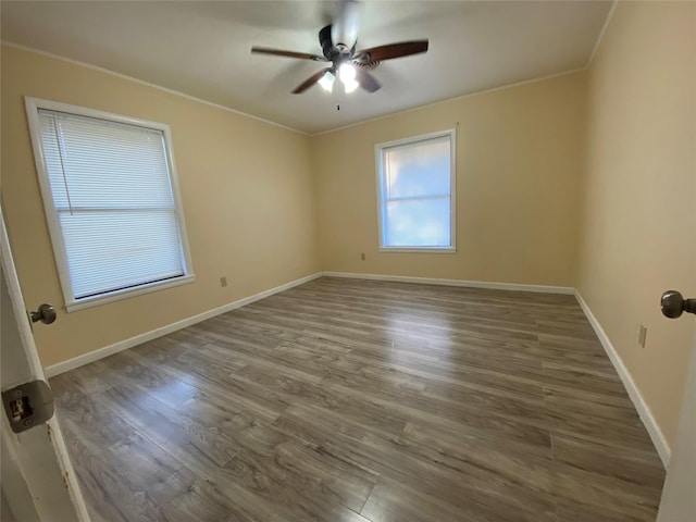 spare room with hardwood / wood-style floors, ceiling fan, and crown molding