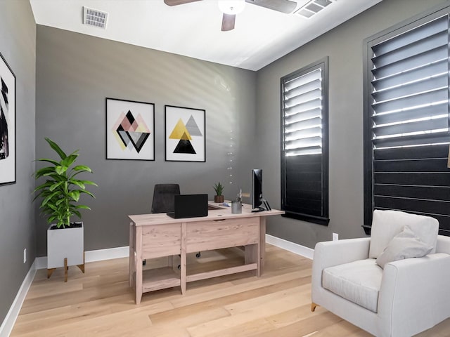 office with ceiling fan and light hardwood / wood-style flooring