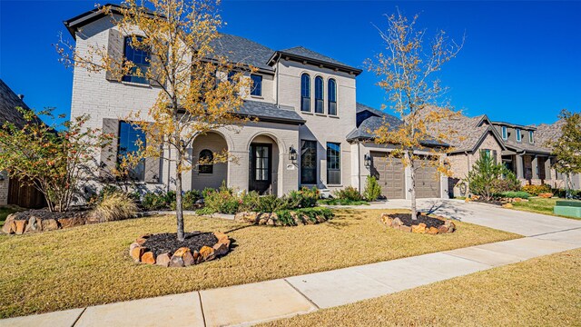 view of front of home with a front yard and a garage