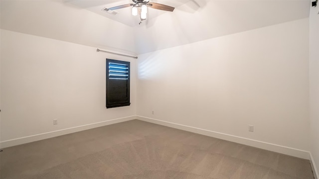 empty room featuring ceiling fan, lofted ceiling, and carpet floors