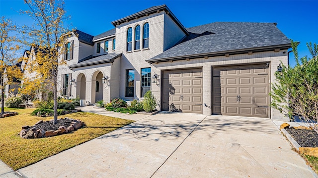 view of front of house with a garage and a front lawn