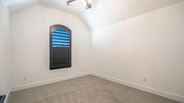 unfurnished room featuring lofted ceiling, light colored carpet, and ceiling fan