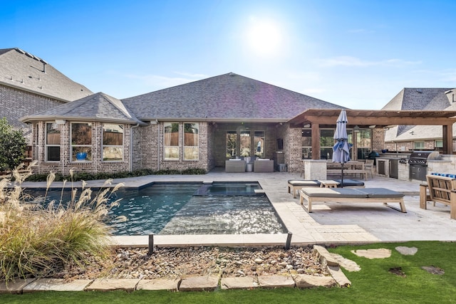 view of pool featuring a grill, an outdoor hangout area, a patio, and exterior kitchen