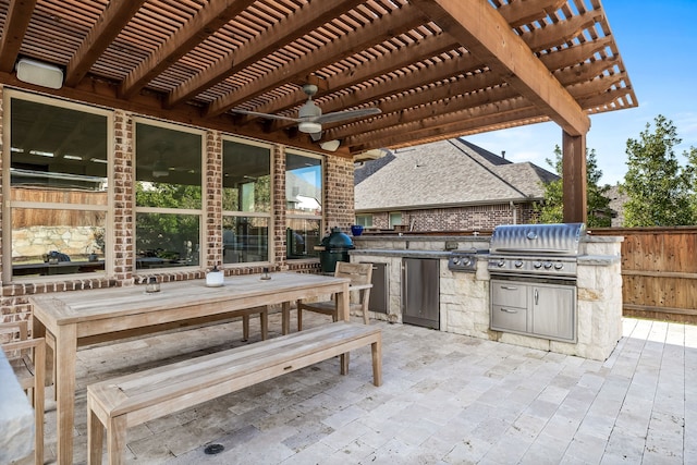 view of patio featuring area for grilling, a pergola, ceiling fan, and an outdoor kitchen