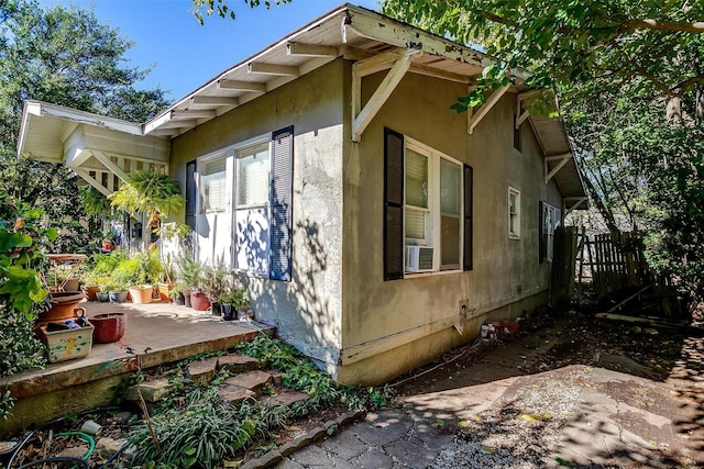 view of side of property featuring cooling unit and a patio area