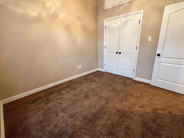 unfurnished bedroom with carpet and a closet