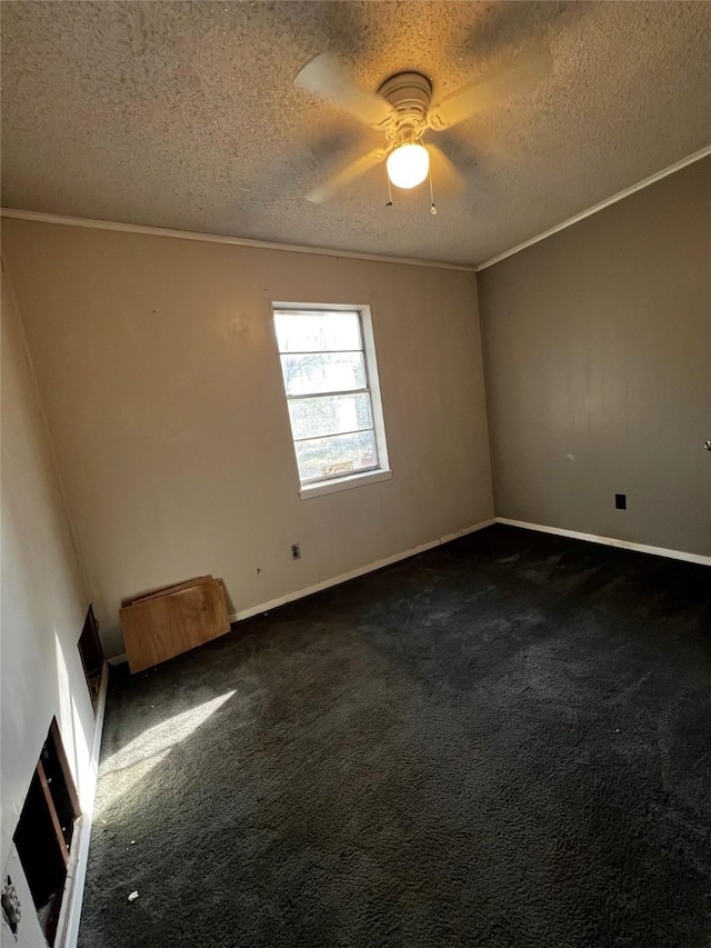 carpeted empty room with ceiling fan, ornamental molding, and a textured ceiling