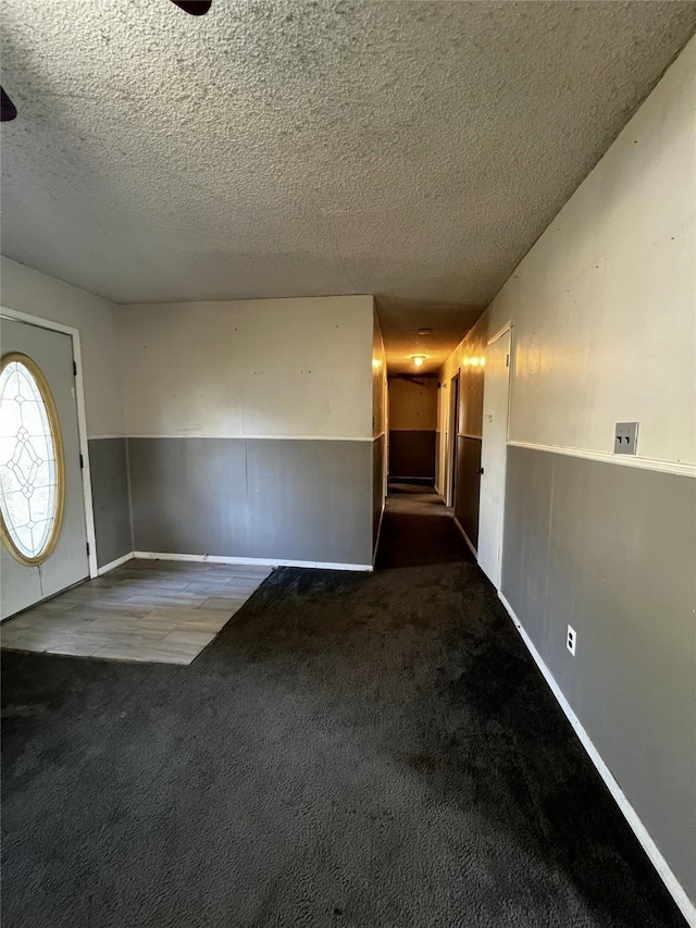 entrance foyer featuring carpet and a textured ceiling