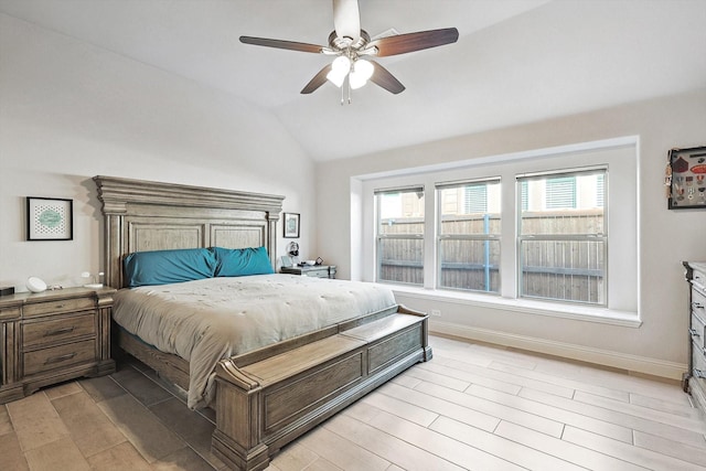 bedroom featuring lofted ceiling, light wood-type flooring, and ceiling fan