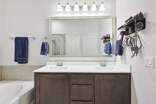 bathroom featuring vanity and shower with separate bathtub