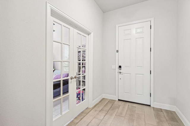 entrance foyer featuring french doors and light hardwood / wood-style floors