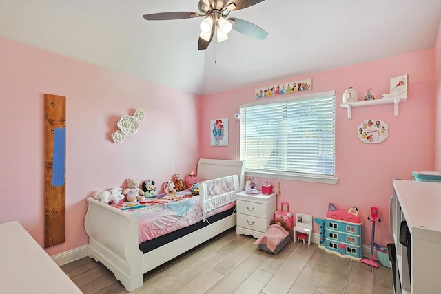 bedroom with lofted ceiling, light hardwood / wood-style floors, and ceiling fan