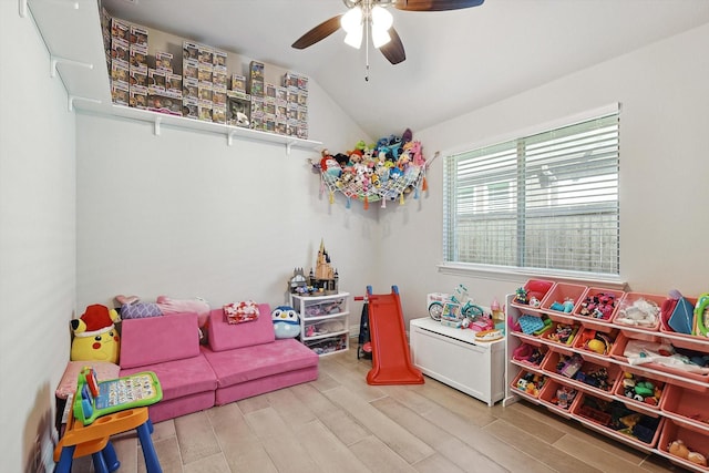 game room with lofted ceiling, hardwood / wood-style floors, and ceiling fan