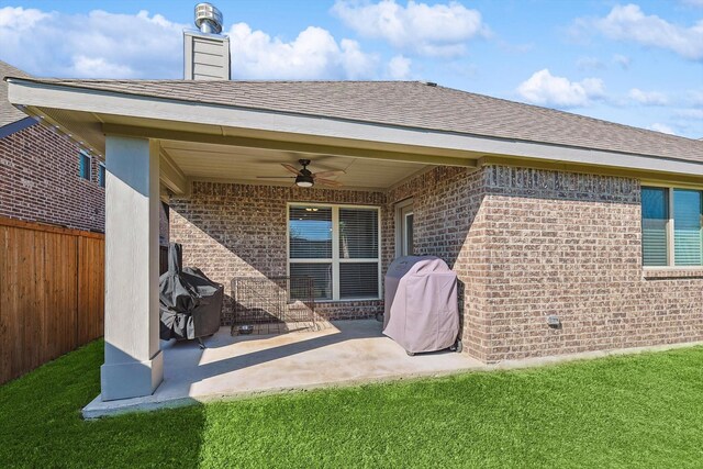 back of property featuring a yard, a patio, and ceiling fan