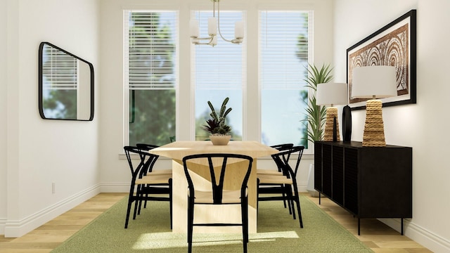 dining room with a chandelier and light hardwood / wood-style flooring