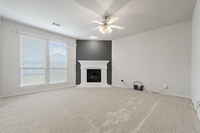 unfurnished living room featuring carpet floors and ceiling fan