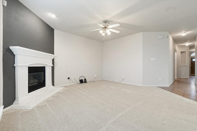 unfurnished living room with ceiling fan and light colored carpet