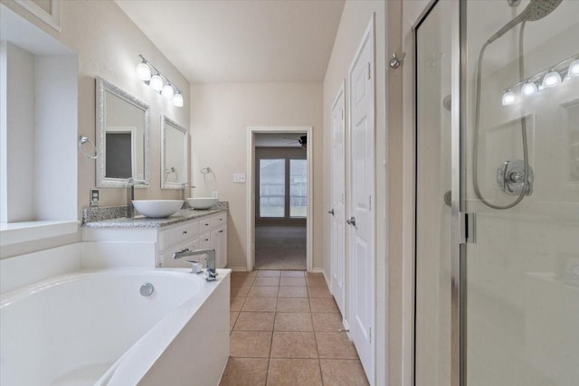 bathroom featuring vanity, tile patterned flooring, and shower with separate bathtub