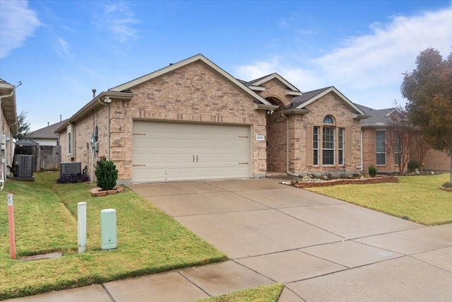 ranch-style house featuring a front lawn, central AC, and a garage